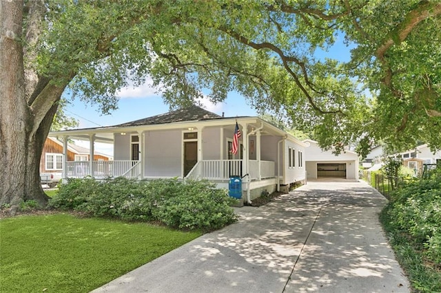 202 Amelia St, Destrehan, LA 70047 - view of front of property with covered porch, a front lawn, and a garage