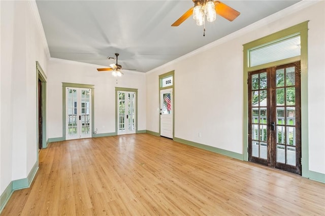202 Amelia St, Destrehan, LA 70047 - empty room with french doors, a ceiling fan, crown molding, wood finished floors, and plenty of natural light
