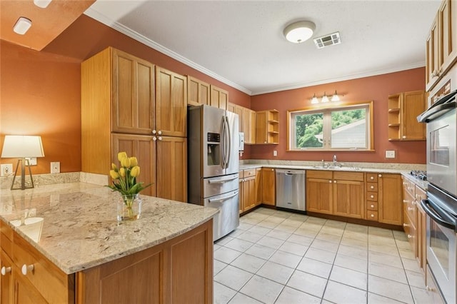 202 Amelia St, Destrehan, LA 70047 - kitchen with appliances with stainless steel finishes, open shelves, a peninsula, light stone counters, and brown cabinets