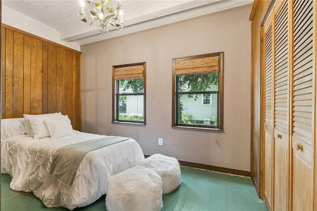 202 Amelia St, Destrehan, LA 70047 - bedroom featuring a chandelier, wood finished floors, beam ceiling, and a closet