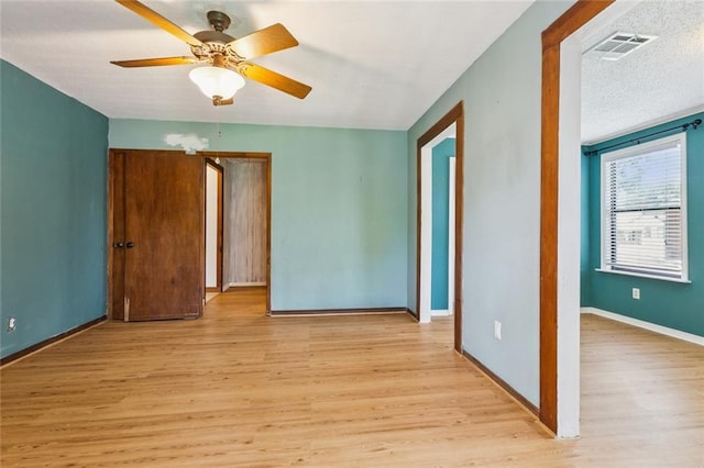 202 Amelia St, Destrehan, LA 70047 - empty room with wood finished floors, a ceiling fan, and a textured ceiling