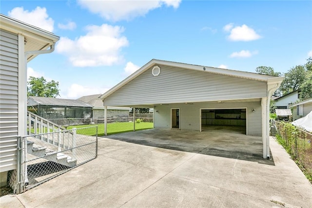 202 Amelia St, Destrehan, LA 70047 - garage with concrete driveway and a carport