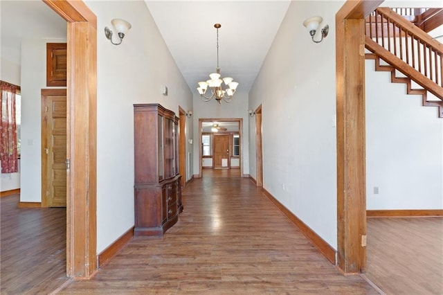 805 Ave A, Marrero, LA 70072 - corridor featuring wood finished floors, a chandelier, stairway, and a towering ceiling