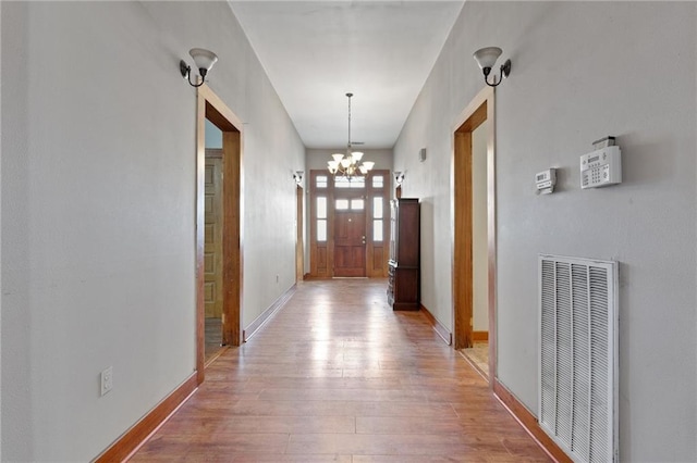 805 Ave A, Marrero, LA 70072 - hallway with a heating unit, light wood-type flooring, and a chandelier