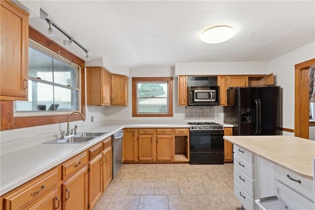 805 Ave A, Marrero, LA 70072 - kitchen with stainless steel appliances, light countertops, track lighting, and brown cabinets