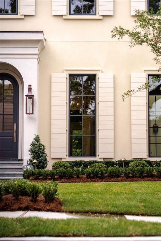 209 Avenue E Ave E, Metairie, LA 70005 - property entrance featuring a yard and stucco siding