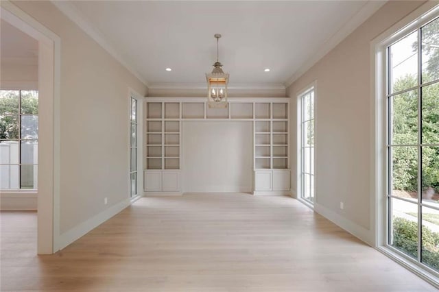 209 Avenue E Ave E, Metairie, LA 70005 - spare room featuring ornamental molding, light wood finished floors, a chandelier, and built in features