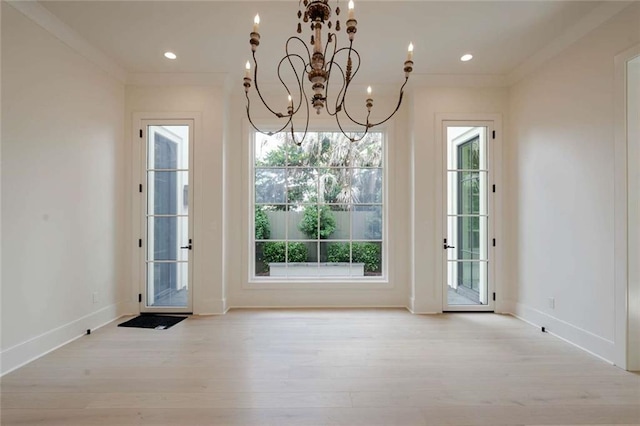 209 Avenue E Ave E, Metairie, LA 70005 - doorway featuring light wood-type flooring, a chandelier, ornamental molding, and recessed lighting