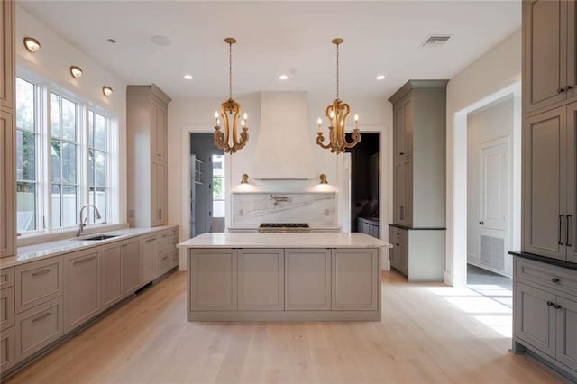 209 Avenue E Ave E, Metairie, LA 70005 - kitchen featuring custom exhaust hood, gray cabinetry, a chandelier, and recessed lighting