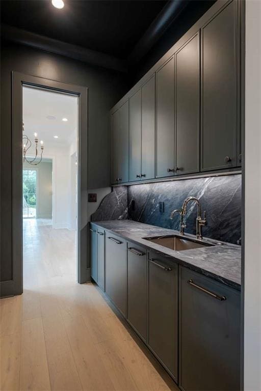 209 Avenue E Ave E, Metairie, LA 70005 - kitchen featuring decorative backsplash, dark countertops, a chandelier, light wood-style floors, and recessed lighting