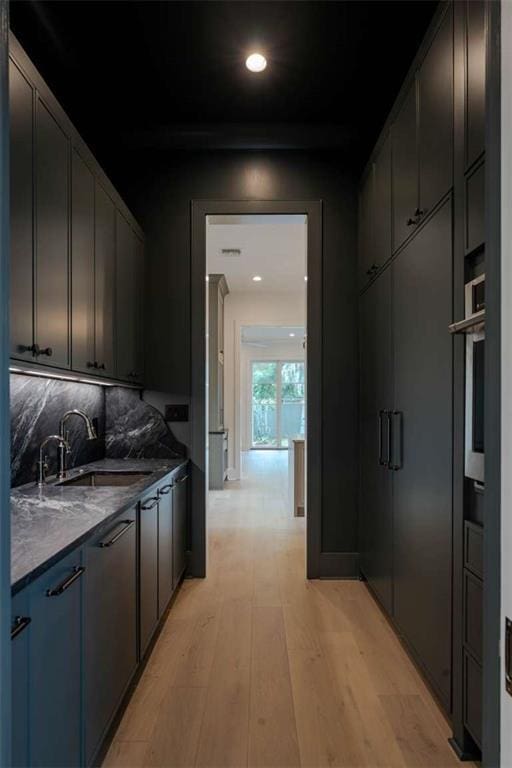 209 Avenue E Ave E, Metairie, LA 70005 - kitchen with light wood-style floors, oven, dark countertops, and recessed lighting