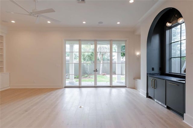 209 Avenue E Ave E, Metairie, LA 70005 - unfurnished living room with plenty of natural light, ornamental molding, light wood finished floors, and recessed lighting