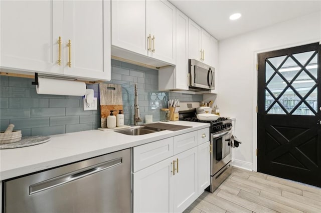 2900 Somerset Dr, New Orleans, LA 70131 - kitchen with appliances with stainless steel finishes, white cabinetry, light countertops, light wood-type flooring, and recessed lighting