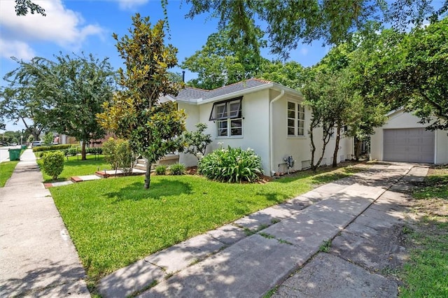 53 Beverly Garden Dr, Metairie, LA 70001 - view of property exterior featuring a lawn, driveway, stucco siding, and an attached garage