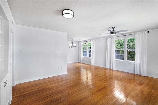 53 Beverly Garden Dr, Metairie, LA 70001 - spare room with a chandelier, a ceiling fan, healthy amount of natural light, and wood finished floors