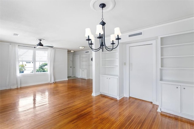 53 Beverly Garden Dr, Metairie, LA 70001 - unfurnished dining area with a chandelier, built in shelves, light wood finished floors, and ceiling fan