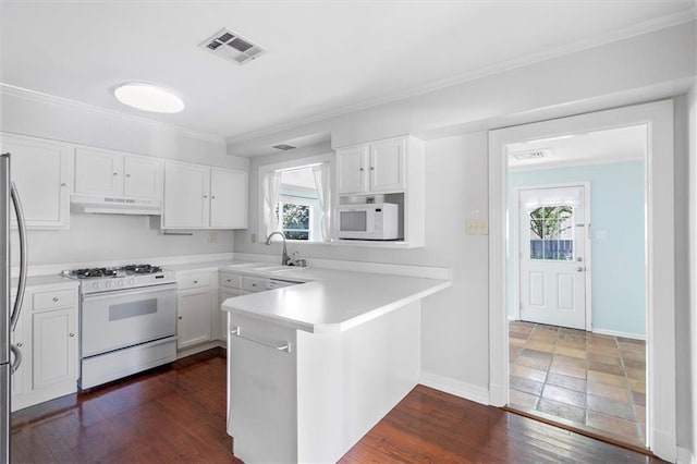 53 Beverly Garden Dr, Metairie, LA 70001 - kitchen featuring white appliances, under cabinet range hood, a peninsula, white cabinets, and light countertops