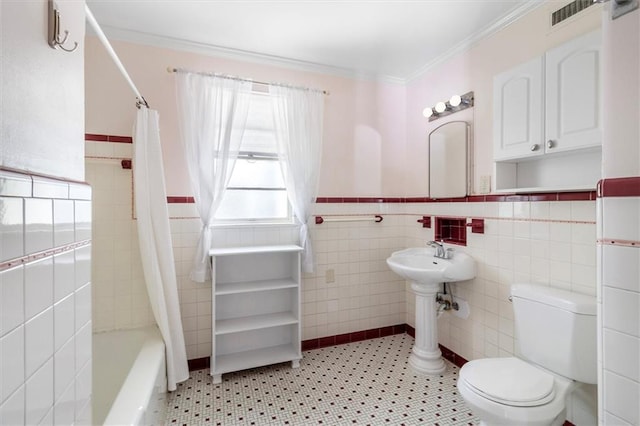 53 Beverly Garden Dr, Metairie, LA 70001 - full bathroom featuring shower / bath combination with curtain, ornamental molding, tile walls, tile patterned floors, and a wainscoted wall