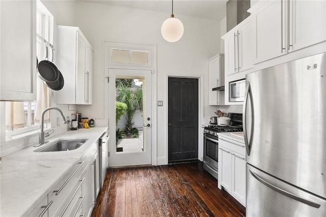 1123 Cadiz St, New Orleans, LA 70115 - kitchen with stainless steel appliances, dark wood-type flooring, and white cabinets