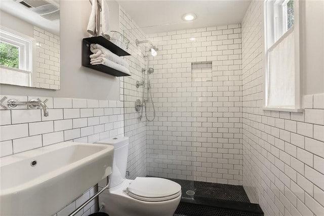 1123 Cadiz St, New Orleans, LA 70115 - full bathroom with tile walls, a shower stall, a wainscoted wall, and recessed lighting