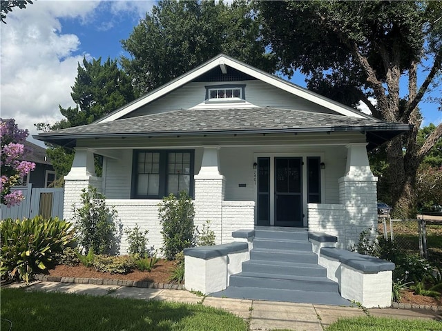 1401 Jefferson St, Gretna, LA 70053 - view of front of house featuring brick siding, covered porch, and a shingled roof