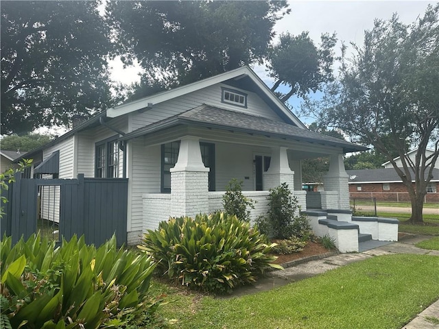1401 Jefferson St, Gretna, LA 70053 - view of front of home featuring covered porch, brick siding, and roof with shingles