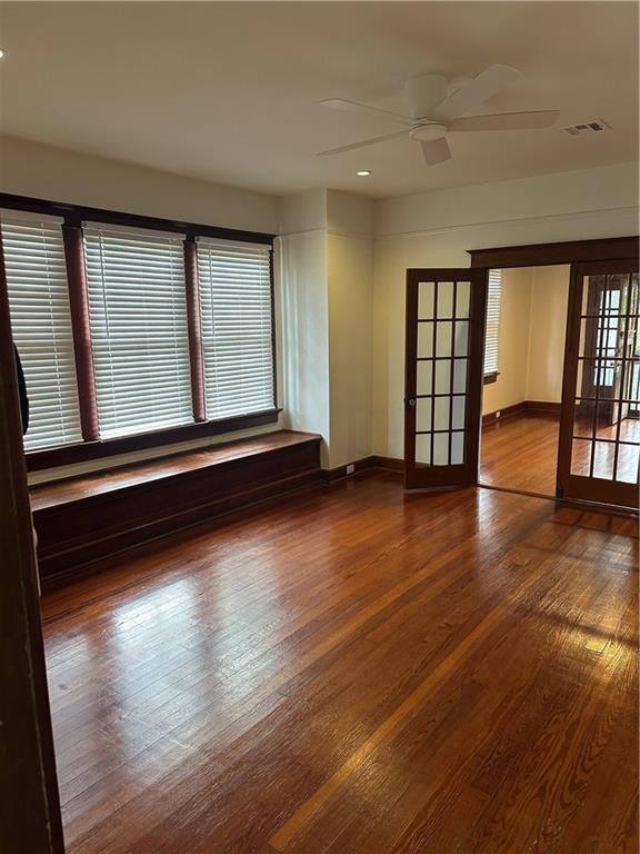 1401 Jefferson St, Gretna, LA 70053 - spare room featuring french doors, wood finished floors, healthy amount of natural light, a ceiling fan, and recessed lighting