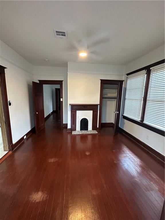 1401 Jefferson St, Gretna, LA 70053 - unfurnished living room with dark wood-style floors and a fireplace with flush hearth