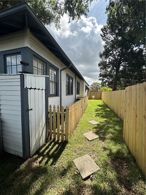 1401 Jefferson St, Gretna, LA 70053 - fenced backyard with an outdoor structure
