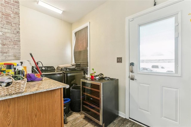 1640 Poland Ave, New Orleans, LA 70117 - laundry room with wood finished floors, separate washer and dryer, and beverage cooler