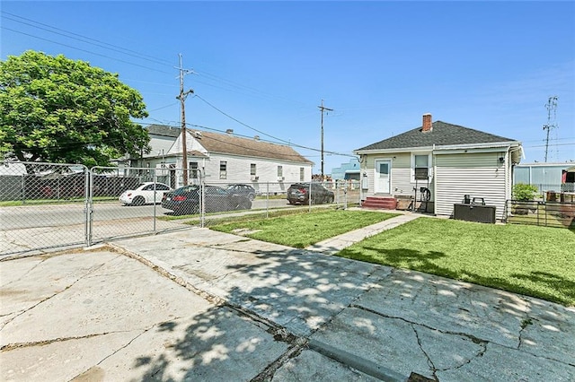 1640 Poland Ave, New Orleans, LA 70117 - back of house featuring a gate, a chimney, and concrete driveway