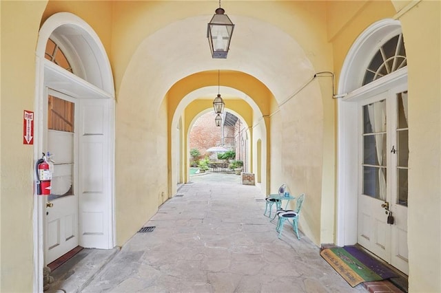 1303 Burgundy St Unit 3, New Orleans, LA 70116 - view of exterior entry with stucco siding and french doors