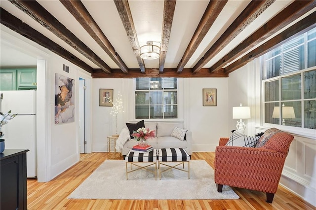 1303 Burgundy St Unit 3, New Orleans, LA 70116 - living area with beam ceiling and light wood-style flooring