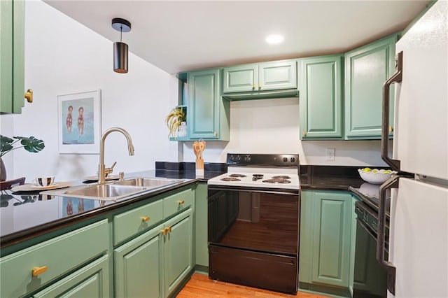 1303 Burgundy St Unit 3, New Orleans, LA 70116 - kitchen with electric stove, freestanding refrigerator, black dishwasher, dark countertops, and green cabinetry