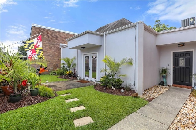 159 Valerie St, River Ridge, LA 70123 - property entrance with french doors, stucco siding, a yard, and brick siding