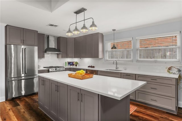 159 Valerie St, River Ridge, LA 70123 - kitchen with stainless steel fridge, wall chimney exhaust hood, stove, gray cabinets, and light countertops