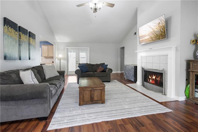 3225 Ridgeline Dr, Slidell, LA 70460 - living room featuring high vaulted ceiling, a ceiling fan, a tile fireplace, and wood finished floors