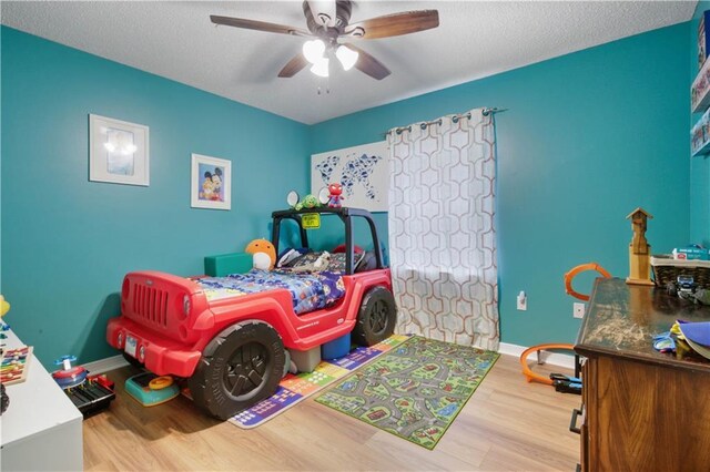 3225 Ridgeline Dr, Slidell, LA 70460 - bedroom featuring wood finished floors, a ceiling fan, and a textured ceiling