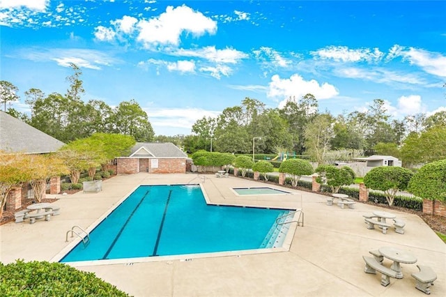 3225 Ridgeline Dr, Slidell, LA 70460 - community pool featuring a patio area and view of wooded area