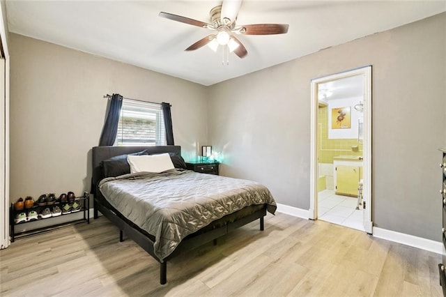 225 E Casa Calvo St, Chalmette, LA 70043 - bedroom with light wood finished floors, connected bathroom, and ceiling fan