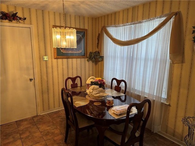 6655 Dalark Dr, Baton Rouge, LA 70812 - dining space with wallpapered walls, a chandelier, and a textured ceiling