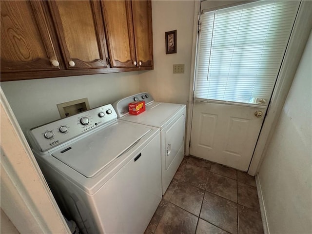 6655 Dalark Dr, Baton Rouge, LA 70812 - washroom featuring separate washer and dryer, cabinet space, and dark tile patterned flooring