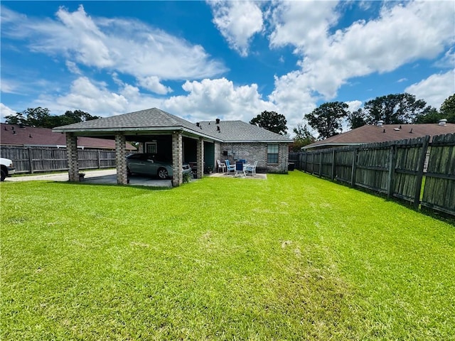 6655 Dalark Dr, Baton Rouge, LA 70812 - back of house with a fenced backyard, an attached carport, a shingled roof, and a patio area