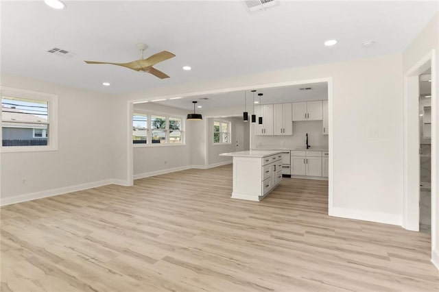 40 Holly Dr, Gretna, LA 70053 - unfurnished living room featuring light wood-style floors, ceiling fan, and recessed lighting