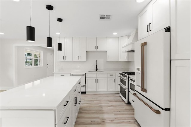 40 Holly Dr, Gretna, LA 70053 - kitchen featuring white appliances, custom exhaust hood, white cabinets, light countertops, and recessed lighting