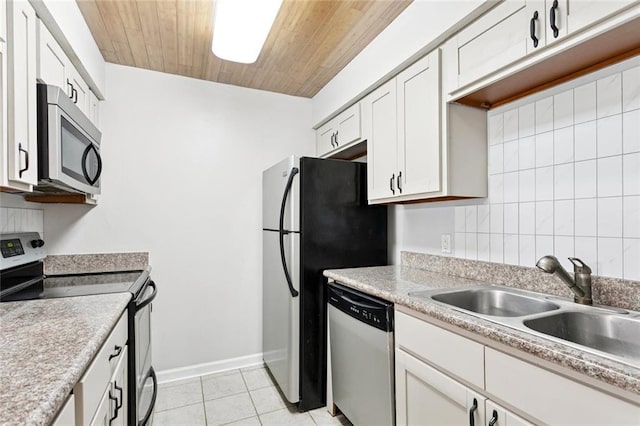 108 Parkview Blvd Unit 108, Mandeville, LA 70471 - kitchen featuring stainless steel appliances, white cabinets, light tile patterned floors, wooden ceiling, and light countertops