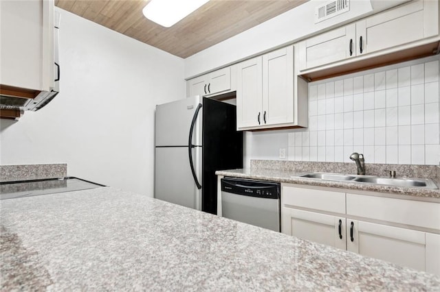 108 Parkview Blvd Unit 108, Mandeville, LA 70471 - kitchen featuring stainless steel dishwasher, freestanding refrigerator, decorative backsplash, white cabinets, and light countertops