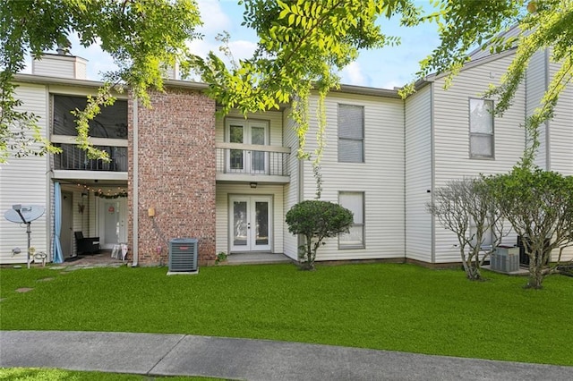 108 Parkview Blvd Unit 108, Mandeville, LA 70471 - back of house with french doors and a lawn