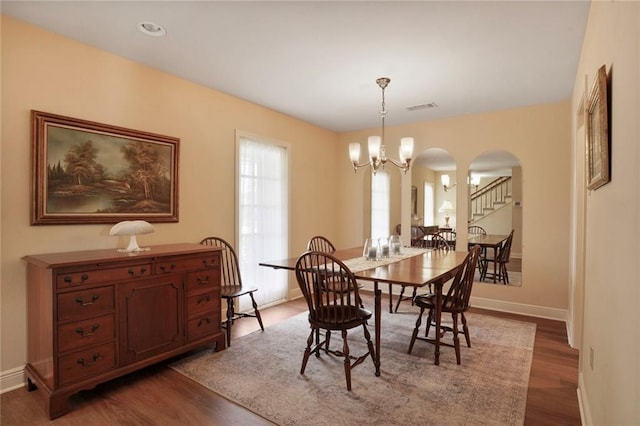 4740 Avron Blvd, Metairie, LA 70006 - dining area featuring arched walkways, wood finished floors, and a chandelier