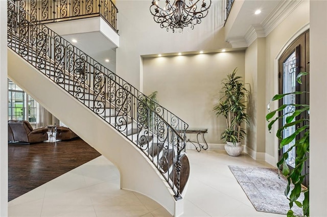 24 Royal Palm Dr, Kenner, LA 70065 - staircase with a high ceiling, crown molding, a chandelier, and tile patterned flooring